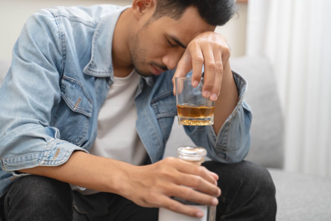 Melancholy,Young,Asian,Man,Drinks,Alcoholic,Whisky,Alone,At,Home alkohol w UK